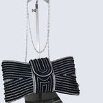 Black beaded clutch bag with a bow on a white background